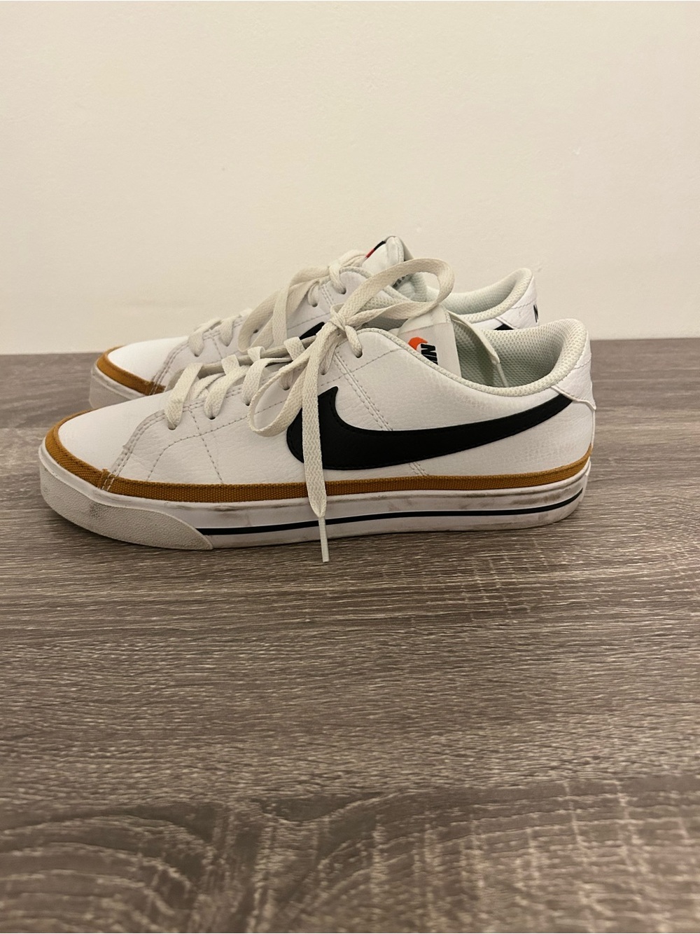 Nike White Low-Top Sneakers with Black Swoosh and Brown Trim